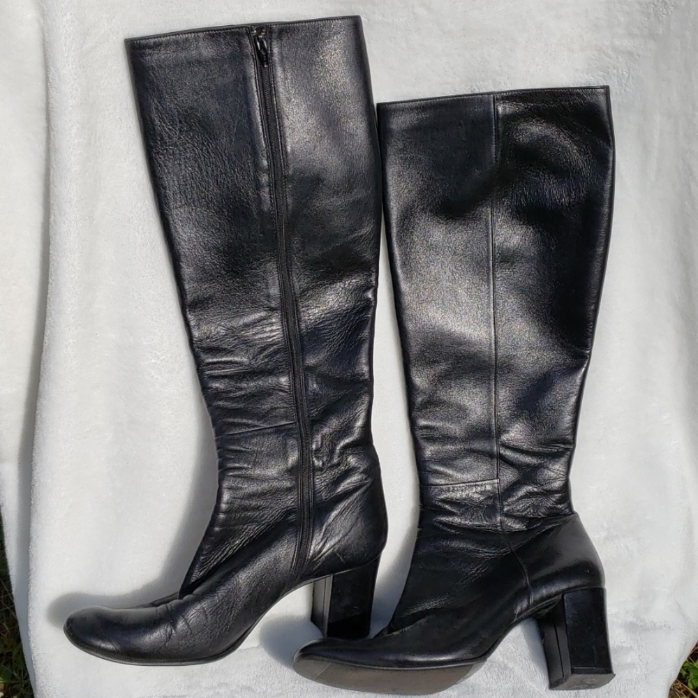 Supple black leather knee high boots.  Zip up